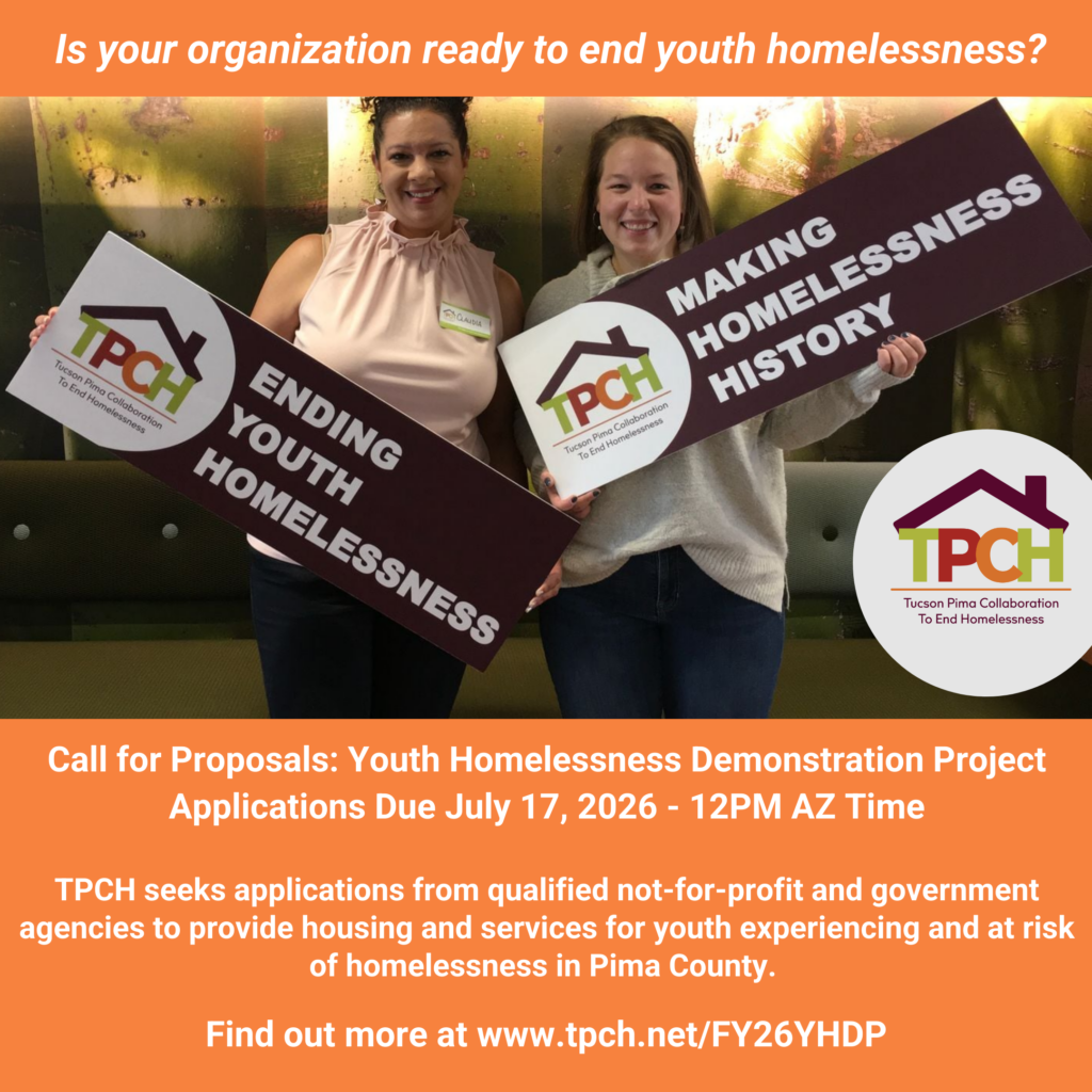 Two individuals holding end youth homelessness signs. Text inviting pre-applications.